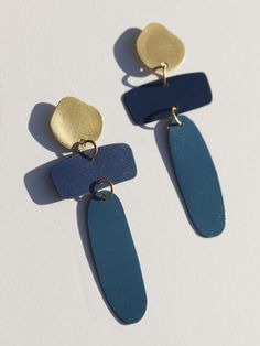 Two tone blue with a touch of matte gold, all stacked together for an artsy abstract vibe. Fair trade Handcrafted in India Ultramarine blue coated over brass Hypoallergenic & nickel free Measures 2.75" in length Bold Handmade Blue Earrings, Bold Blue Handmade Earrings, Bold Blue Drop Earrings, Blue Brass Dangle Earrings, Minimalist Blue Brass Earrings, Modern Blue Metal Earrings, Handmade Bold Blue Jewelry, Bold Handmade Blue Jewelry, Bold Blue Earrings For Gift