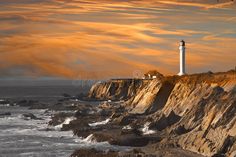 a lighthouse on the edge of a rocky cliff