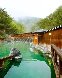 the water is green and there are wooden buildings in the background