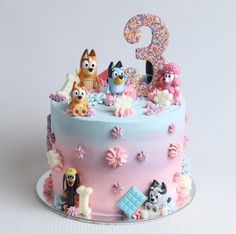 a birthday cake with the number nine on it's top and several cartoon characters