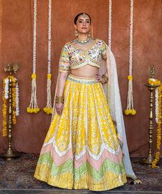 Step into the spotlight with our breathtaking Mehereen Lehenga. This ethereal ensemble captures a whimsical allure, adorned with precious mirrors, pearls, stones, and exquisite embroidery work. With its evergreen yellow hue, this lehenga is a stunning choice for weddings and bridal occasions, exuding grace and grandeur. Dazzle in this exquisite Mehereen Lehenga, a true masterpiece of elegance. Adorned with precious mirrors, pearls, and stones, it captures a whimsical allure that is truly mesmeri Yellow Cutdana Sets For Reception, Yellow Cutdana Sharara For Reception, Yellow Gota Work Sets For Reception, Yellow Sets With Dori Work For Reception, Yellow Mirror Work Sets For Reception, Yellow Sets With Mirror Work For Reception, Yellow Anarkali Set With Mirror Work, Designer Yellow Choli With Gota Work, Yellow Choli With Mirror Work For Diwali