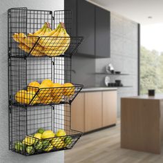 three metal baskets filled with fruit sitting on top of a wall next to a kitchen counter