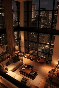 a living room filled with furniture and tall buildings in the background at night, lit up by lights from windows