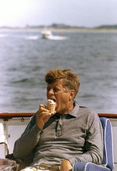 an older man eating ice cream on a boat