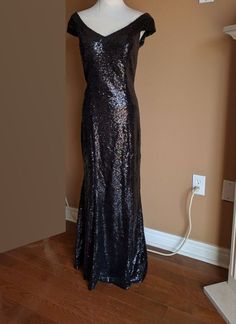 a black sequin dress on display in a room