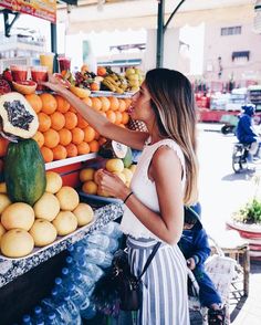 the instagram page shows an image of a woman buying fruit