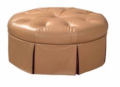 a round leather ottoman with pleated skirting on the front and back end,