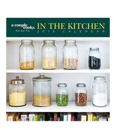 the cover of a cookbook in the kitchen, featuring jars filled with grains and cereals