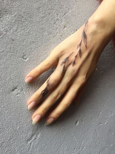 a woman's hand with tattoos on it