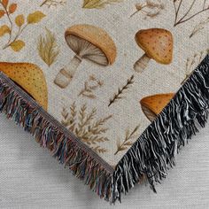 a close up of a blanket with mushrooms on it