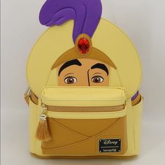 Prince Ali Is A Faux Leather Mini Backpack. It Features Print, Debossing, And Embroidered Details. He Has A 3d Jewel In His Turban, The Plume Is Debossed, The Front Pocket Is Accented By An Elegant Tassel Zipper Pull. The Custom Interior Lining Is His Trusted Friend Carpet. The Back Of The Bag Is Printed “Do You Trust Me?” Which Is Also Debossed. This Bag Is An Officially Licensed Disney Product. Bag Dimensions Are: W: 9” X H: 12” X D: 4.5” Note: The Measurements Include The Height Of His Turban Character Style Travel Backpack, Character Style Standard Backpack For Travel, Themed Cosplay Backpack, Themed Backpack With Case Included, Aladdin Prince Ali, Prince Ali, Pink Tea Party, Aladdin Disney, Belle Cosplay