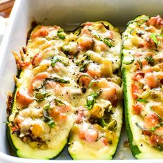 zucchini stuffed with shrimp and cheese in a white dish