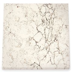 a white marble counter top with cracks in the middle and brown veining on it