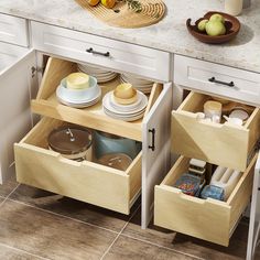 two open drawers in a kitchen with plates and bowls on the counter top next to each other