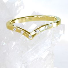 a gold ring with three diamonds on it