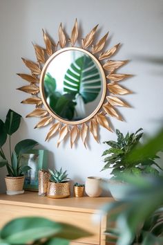 a mirror sitting on top of a wooden table next to plants and potted plants