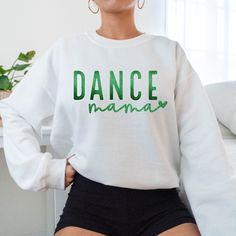 Does your mama spend most of her time at the Dance studio? Personalize Mom's sleeve with dancer's name & heart. These tees & sweaters are a great gift for birthdays, Mother's Day, Valentine's Day or Christmas! You can customize the print colors in the personalization section to reflect your favorite school or team. To add lounge pants, knit scarves, hats, expedite processing, add overnight shipping, and any other miscellaneous items- please follow this link: https://www.etsy.com/shop/KASPDesign?ref=seller-platform-mcnav§ion_id=27547745 Listing is for one garment.  To order... 1. Select the style and size you would like, then the color for the garment.  2. In the personalization section pick one color for the print. Please make sure to let me know if the color is glittered or matte. 3. Then Long Sleeve Tops For Fall Dance, Casual Long Sleeve Tops For Dance, Casual Cotton Sweatshirt For Dance, Long Sleeve Tops With Letter Print For Dance Class, Long Sleeve Letter Print Top For Dance Class, Casual Long Sleeve Tops For Dance Class, Casual Letter Print Sweatshirt For Dance, Casual Long Sleeve Sweatshirt For Dance, Relaxed Fit Long Sleeve Tops For Dance Class