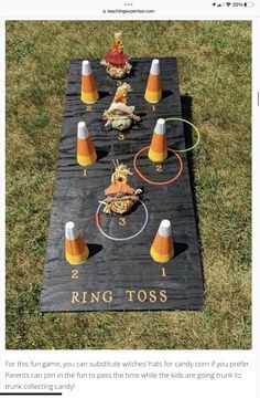 an image of a cornhole game set up in the grass with orange cones on it