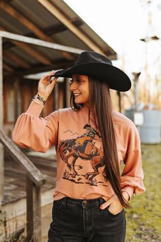 Ride into the Wild West with our Cowboy Rider Graphic Sweatshirt. Featuring trendy balloon sleeves and crafted on French Terry for an unmatched level of comfort, this sweatshirt effortlessly combines fashion and coziness. The standout cowboy rider graphic adds a rugged charm to your casual wardrobe, making it a must-have for those who crave a uniquely designed top. Trendy Long Sleeve Tops For Outdoor, Western Long Sleeve Tops For Outdoor, Western Style Long Sleeve Tops For Outdoor, Oversized Long Sleeve Tops For Outdoor, Western Style Relaxed Fit Long Sleeve Tops, Western Style Long Sleeve Cotton Tops, Western Style Long Sleeve Relaxed Fit Tops, Long Sleeve Tops For Rodeo In Winter, Long Sleeve Top For Ranch In Fall