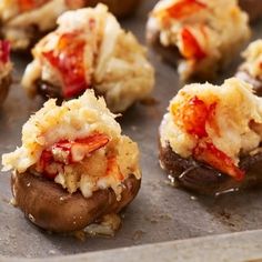 stuffed mushrooms with toppings on a baking sheet