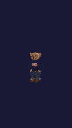 a teddy bear wearing a sweater and jeans standing in front of a dark blue background