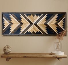 a wooden wall hanging over a shelf in a room