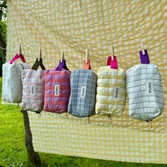 towels hanging on a clothes line in front of a yellow checkered cloth covered wall