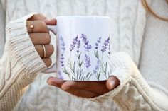 a woman holding a coffee mug with lavender flowers on it