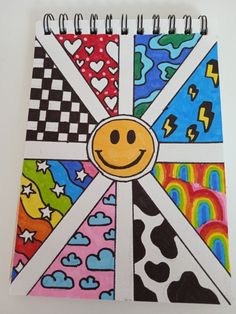 a colorful spiral notebook with a smiley face on it