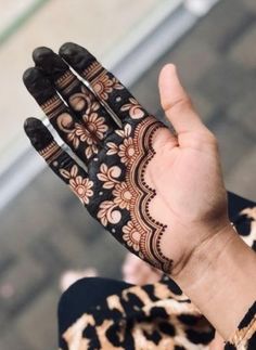 a woman's hand with henna on it