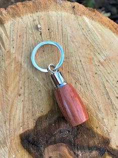 a wooden keychain with a metal ring on it