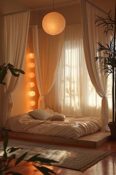 a bed with white curtains and lights hanging from it's sides in a bedroom