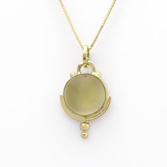 This lovely golden moonstone amulet is SASA's trademarked Art Deco style in a handmade 14K yellow gold setting. Little solid 'bubbles' of gold on the tip add sparkle when light falls upon them. According to Hindu mythology, moonstone is made of solidified moonbeams. Many other cultures also associate this gem with moonlight, and it's easy to see why. Its internal structure scatters the light that strikes it, creating a phenomenon known as adularescence. The visual effect is reminiscent of the fu Heirloom Gold Moonstone Jewelry, Formal Yellow Gold Chalcedony Jewelry, Gold Moonstone Round Stone Jewelry, Gold Moonstone Jewelry With Round Stone, Gold Polished Moonstone Jewelry, Gold Moonstone Jewelry With Polished Finish, Unique Yellow Gold Necklace With Cabochon, Yellow Gold Moonstone Jewelry, Vintage Gold Moonstone Jewelry