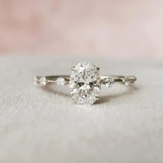 an oval cut diamond ring with side stones