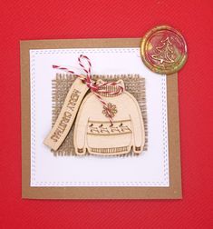 a christmas ornament on a card with a wax stamp