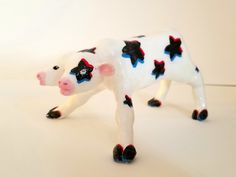 a toy cow with red, white and blue stars on it's body