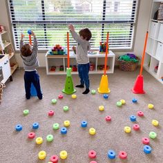 two children playing with toys in a playroom