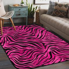 a living room area with a couch, chair and rug in pink and black zebra print