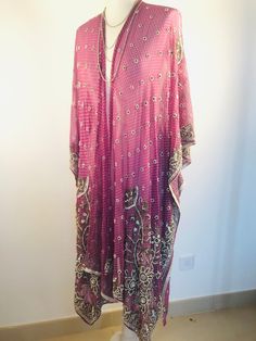 "A Unique and Truly Beautiful Kimono Jacket. This has been Handmade from a Vintage Indian Silk Sari.... so is completely Original and one of a kind. A Wonderfully Chic, flattering colour way of Dusky Lilac,Embellished with allover Beads and Sequins that Sparkle and catch the Light. The Gorgeous embroidery design has 1000's of Silver bugle beads , Pearly white beads and Glittering Crystals. This Stunning 3/4 length Jacket is made in Silk Chiffon ,so drapes elegantly ,with loose Waterfall sleeves Long Purple Festive Kaftan, Festive Long Purple Kaftan, Traditional Sequined Kaftan For Weddings, Traditional Wedding Sequined Kaftan, Long Kaftan With Dupatta For Wedding, Pink Zari Work Kaftan For Party, Wedding And Festival Sequined Kaftan, Long Wedding Kaftan With Dupatta, Pink Sequined Kaftan For Party