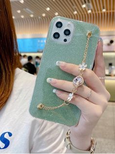 a woman is holding up her phone case