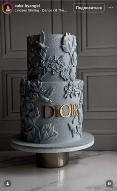 a three - tiered cake decorated with flowers and the word dor on it