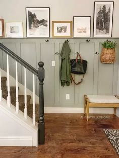 the entryway is clean and organized with pictures on the wall, coat rack, and bench