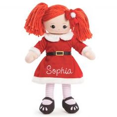 a red and white doll with long hair wearing a santa claus outfit that says,'sophia '