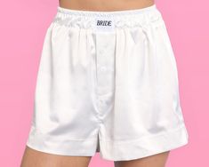 ✨Bridal Bliss: Have some fun in our white satin boxer shorts featuring a white woven tag with black BRIDE text. ✨For Every Bride: Our premium boxer shorts come in 3 sizes - Small, Medium, and Large!  ✨Ultimate Comfort: We made the *comfiest* shorts ever to support you all bach long! Made of 5% Spandex and 95% Polyester. ✨Easy Care: We kept it super easy for the bride to be. Simply machine wash cold + tumble dry!  ✨Cute Stuff Inside: and outside, too! Every sandal comes gift-ready for your favori Old Pajamas, Boxers Outfit, Bride In Black, We're Getting Married, Wifey Sweatshirt, Bachelorette Party Outfit, Bridal Accessory, Honeymoon Outfits, White Bride