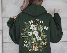 NOTE: This design is on the BACK SIDE ONLY. The front is left blank.  A unique watercolor butterfly, floral and mushroom hoodie, perfect for your cottagecore clothing collection! The most popular hooded sweatshirt, the Gildan medium-heavy blend fleece is the perfect mix of 8 oz 50% cotton and 50% polyester. Ideal for any situation, a unisex heavy blend hooded sweatshirt is pure comfort. There are no itchy side seams on these sweaters (BONUS---Whoop!). Please see size chart in listing images Sizi Spring Cotton Sweatshirt For Outdoor, Cotton Sweatshirt For Outdoor Spring Activities, Relaxed Fit Hoodie For Spring Outdoor Activities, Relaxed Fit Hoodie For Spring Outdoor, Crew Neck Hoodie For Outdoor Spring Activities, Spring Outdoor Cotton Sweatshirt, Spring Crew Neck Hoodie For Outdoor, Casual Hoodie With Custom Print For Fall, Spring Outdoor Sweatshirt With Relaxed Fit