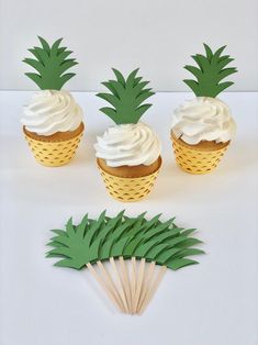 pineapple cupcakes with white frosting on top and green paper straws