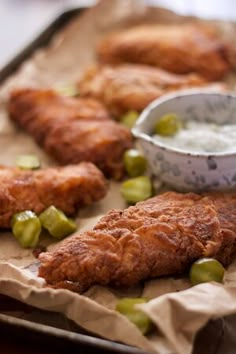 some food is laying out on a tray and ready to be eaten with dipping sauce