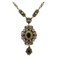 A large vintage gold necklace made in the antique-style with Victorian features. The necklace showcases two amethyst cabochons along with multiple pearls set along the necklace. There is filigree goldwork as well as millgrain which are classic styles of antique jewelry. Made in 14k yellow gold. Necklace Chain Length: 18.5 inches Drop Length: 3 inches Victorian Jeweled Necklaces For Formal Occasions, Ornate Jeweled Necklaces For Formal Occasions, Antique Pearl Necklace For Formal Occasions, Victorian Pearl Necklace For Formal Occasions, Victorian Style Formal Pearl Necklace, Victorian Jeweled Pendant Necklace, Ornate Historical Design Necklaces For Formal Occasions, Ornate Historical Design Necklace For Formal Occasions, Ornate Antique Gold Jewelry With Historical Design