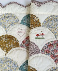 two quilts with different designs on them, one has a heart in the middle