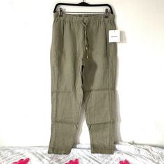 Ellen Tracy Linen Drawstring Casual Pants. Light Olive Green Color. Lightweight, Flowy 100% Linen Material. Elastic Waistband, Drawstring With Gold Tone Grommet Detail. Pocketless Style For Flattering Silhouette. Slight Tapered Leg . Lightweight Material. . Waist 14 1/2” Flat Aprox . Rise 10 1/2” Aprox . Length 28 1/2” Aprox Spring Straight Leg Pants With Drawstring, Khaki Bottoms With Drawstring For Spring, Spring Khaki Bottoms With Drawstring, Khaki Drawstring Bottoms For Spring, Khaki Summer Loungewear Pants, Spring Khaki Drawstring Bottoms, Summer Tapered Leg Bottoms With Drawstring, Spring Khaki Loungewear Pants, Spring Khaki Pants With Drawstring